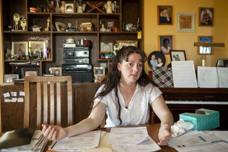Melissa Puchalla of Appleton, Wisconsin shuffles through piles of paper work containing records for Quita, her adopted daughter from Liberia, on May 8, 2013.